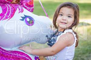 Cute Young Mixed Race Baby Girl Holding Mylar Balloon Outdoors