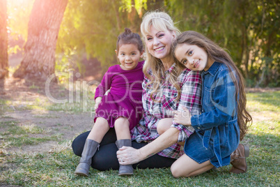 Caucasian Grandmother With Young Mixed Race Grandaughters Outdoors