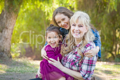 Caucasian Grandmother With Young Mixed Race Grandaughters Outdoors