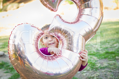 Cute Baby Girl Playing With Number Three Mylar Balloon Outdoors