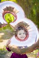 Cute Baby Girl Playing With Number Three Mylar Balloon Outdoors