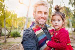 Handsome Caucasian Young Man with Mixed Race Baby Girl Outdoors