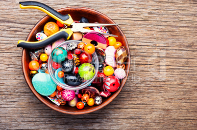 Colorful beads on a wooden surface