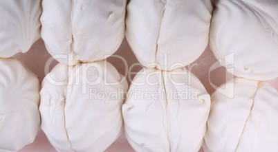 many white marshmallow on pink background at dry day