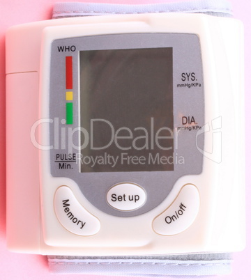 Automatic Wrist Digital blood pressure monitor on pink backgroun