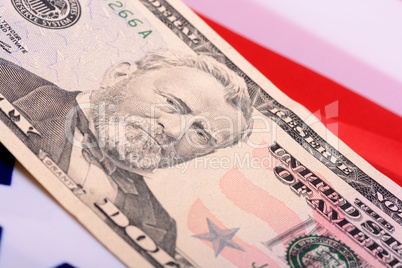 fifty dollar bill in front of the American flag
