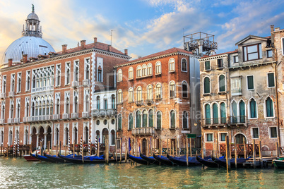 Gondolas of Venice in front of medieval palaces and the dome of