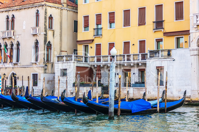 Gondolas moored in front of the terrace of a venetian palace on