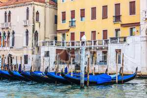 Gondolas moored in front of the terrace of a venetian palace on