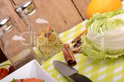 fresh salmon fillet on white plate. knife, cabbage, red pepper, spice, cinnamon and lemon