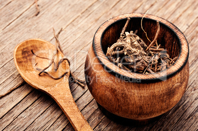 Valerian roots on wooden background