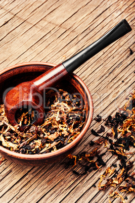 Pipe and tobacco on rustic table