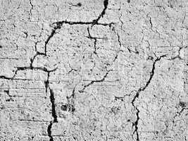 textures of old wall surface painted with white paint and covered with cracks