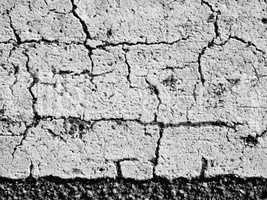 textures of old wall surface painted with white paint and covered with cracks