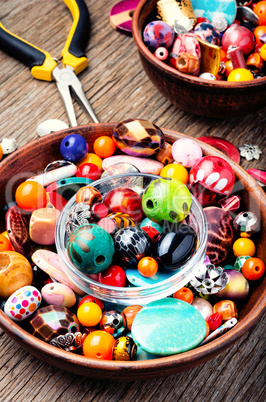 Colorful beads on a wooden surface