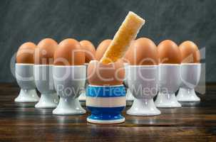Toast Soldier Dipped in Boiled Egg in Egg Cup on a Table