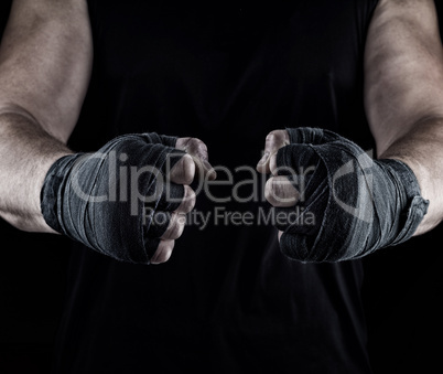 men's hands wrapped in a black bandage