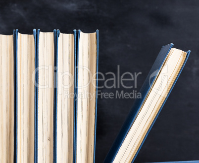 books with blue cover, black background