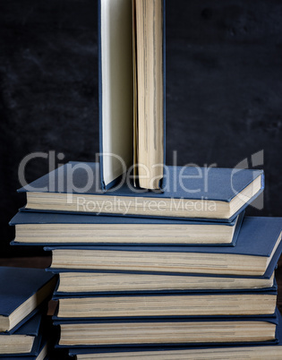 stack of various books, open book on top