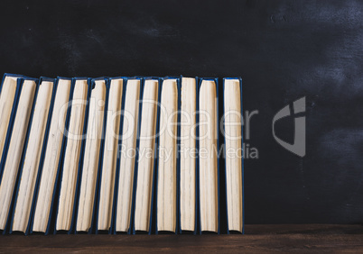 books with blue cover, black background