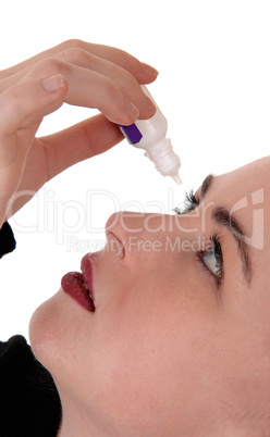 Woman putting eye drops in her eyes