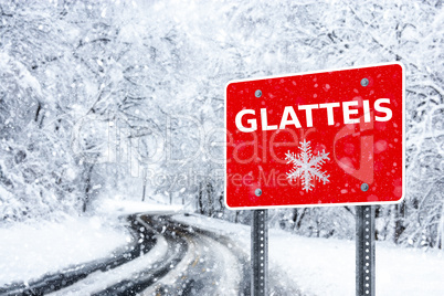 Warning traffic sign on a ice road. Glatteis is the german word for glazed frost
