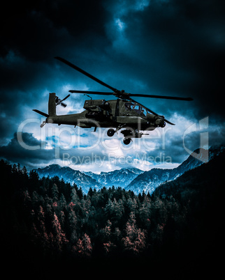Heavy armed attack helicopter flies over hills