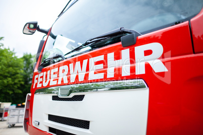 German fire engine stands on a deployment site. The german word Feuerwehr means fire department.