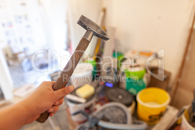 Hand holds a hammer on construction side