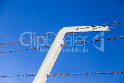 barb wire in front of blue sky