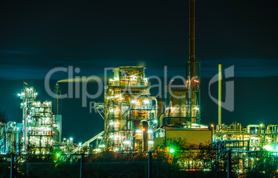 Chemical Factory w illumination, tubes and buildings at night - near