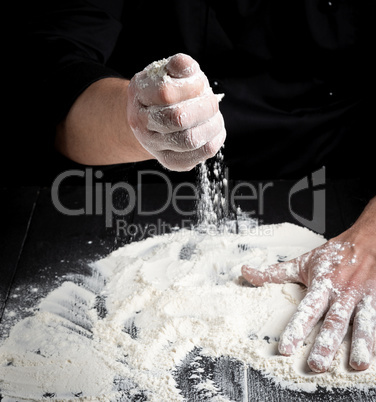 white wheat flour on a black wooden table