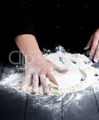 white wheat flour on a black wooden table