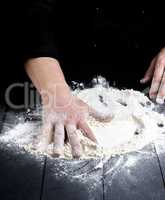 white wheat flour on a black wooden table