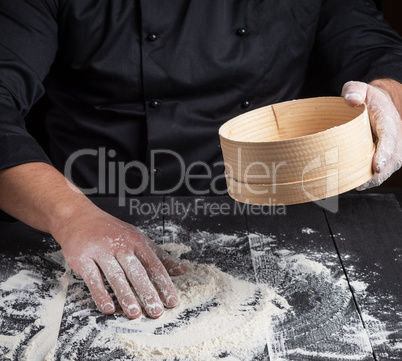 Chef prepares the dough of white flour