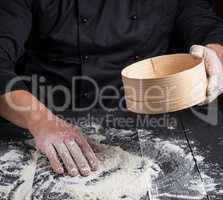 Chef prepares the dough of white flour