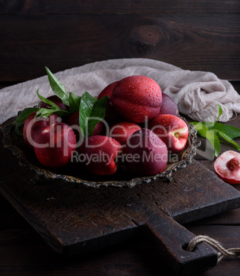 red ripe peaches nectarine in an iron plate