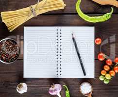 blank notebook with white sheets, raw long paste and ingredients