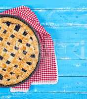 half of fruit pie on blue wooden background