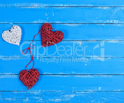 wicker hearts on a blue wooden plank background