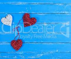 wicker hearts on a blue wooden plank background