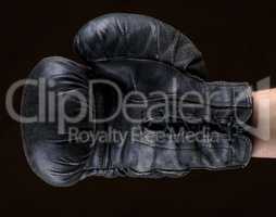 hand in black leather boxing glove