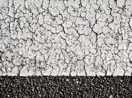 textures of old wall surface painted with white paint and covered with cracks