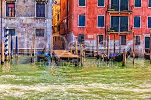 Gondolas moored near a typical narrow street of Venice, Italy