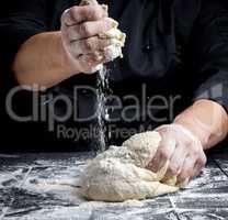 men's hands knead white wheat flour yeast dough