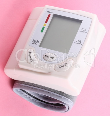 Automatic Wrist Digital blood pressure monitor on pink backgroun