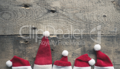 Five hat of Santa on wood