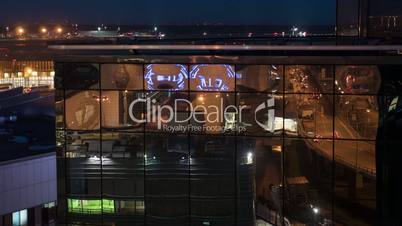 Timelapse of city reflecting in glassy building, night view