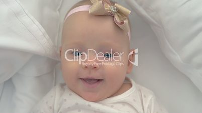 Portrait of smiling blue-eyed baby girl of six months old