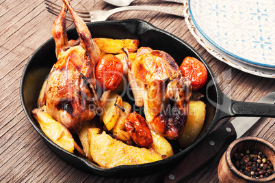 Baked whole quail with potatoes